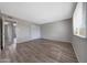 A spacious bedroom is painted in neutral tones and features durable flooring and a large window with blinds at 1619 E Del Rio Dr, Tempe, AZ 85282