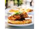 A delicious chicken and waffles dish, enhanced with butter and jalapeño slices, presented on a white plate at 1619 E Del Rio Dr, Tempe, AZ 85282