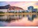 Tranquil view of modern residential buildings by the lake, complemented by Camelback Mountain at 1619 E Del Rio Dr, Tempe, AZ 85282