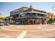 Exterior street view of Varsity Tavern featuring a large building with outdoor seating and vehicular traffic at 1619 E Del Rio Dr, Tempe, AZ 85282