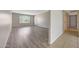 Bright and airy living room with wood-look flooring and a window with natural light at 1619 E Del Rio Dr, Tempe, AZ 85282