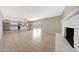 Open concept living room showcases a fireplace, tile flooring, and flows into the modern kitchen at 1619 E Del Rio Dr, Tempe, AZ 85282