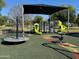A colorful playground featuring slides, climbing structures, and a merry-go-round, designed for fun and active play at 1619 E Del Rio Dr, Tempe, AZ 85282