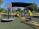Playground featuring colorful play structures including slides, climbing structures and covered picnic area, designed for fun at 1619 E Del Rio Dr, Tempe, AZ 85282