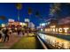 Night view of The District shopping area with restaurants, shops, water feature, and palm trees at 1619 E Del Rio Dr, Tempe, AZ 85282
