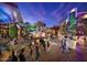 A bustling outdoor Tempe Marketplace featuring pedestrians and palm trees under a colorful twilight sky at 1619 E Del Rio Dr, Tempe, AZ 85282