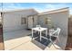 Outdoor seating area with table, chairs, decorative rug and grey brick exterior at 1624 W Thomas Rd, Phoenix, AZ 85015