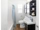 This bathroom features a toilet, sink, vanity and shower with blue patterned curtain at 1624 W Thomas Rd, Phoenix, AZ 85015
