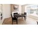 Bright dining room with large window, fireplace, tile floors and an oval wooden table at 1624 W Thomas Rd, Phoenix, AZ 85015