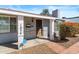Inviting front porch with brick accents and a wood front door with updated fixtures at 1624 W Thomas Rd, Phoenix, AZ 85015