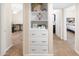 Hallway featuring built in shelving with decor and views of office and bedroom space at 1624 W Thomas Rd, Phoenix, AZ 85015