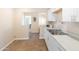 Bright kitchen featuring stainless steel sink, tile floors and white shaker cabinets at 1624 W Thomas Rd, Phoenix, AZ 85015