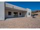 A contemporary home with a covered patio, desert landscaping, and tiered backyard at 16405 N Cobblestone Ln, Fountain Hills, AZ 85268