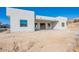 Modern home's backyard area featuring a bright white stucco finish and multiple windows at 16405 N Cobblestone Ln, Fountain Hills, AZ 85268