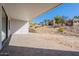 A large covered backyard patio with brick pavers and a view of the hillside at 16405 N Cobblestone Ln, Fountain Hills, AZ 85268