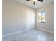 Bright bedroom featuring tile floors, ceiling fan, and a double door closet at 16405 N Cobblestone Ln, Fountain Hills, AZ 85268