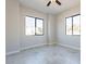 A bright bedroom with gray walls, tile flooring, and large window at 16405 N Cobblestone Ln, Fountain Hills, AZ 85268