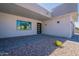 Close up view of the modern one-story home entrance featuring desert landscaping and a paved entranceway at 16405 N Cobblestone Ln, Fountain Hills, AZ 85268