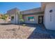 Close up of a modern one-story home featuring desert landscaping, a black front door, and gray accents at 16405 N Cobblestone Ln, Fountain Hills, AZ 85268