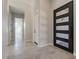 Modern entryway featuring gray tile flooring, white walls, and an exterior glass panel door at 16405 N Cobblestone Ln, Fountain Hills, AZ 85268