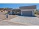 Contemporary one-story home with a grey stucco facade, desert landscaping, and a paved driveway leading to the garage at 16405 N Cobblestone Ln, Fountain Hills, AZ 85268