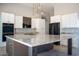 Modern kitchen showcasing an island with granite countertops, stainless steel appliances, and pendant lighting at 16405 N Cobblestone Ln, Fountain Hills, AZ 85268