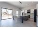 Open kitchen with granite counters, an island, neutral walls, and a large sliding glass door at 16405 N Cobblestone Ln, Fountain Hills, AZ 85268