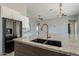 Close up of the large kitchen island with granite countertops and brass faucet at 16405 N Cobblestone Ln, Fountain Hills, AZ 85268