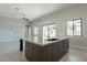 Spacious kitchen with large granite island and modern lighting fixtures at 16405 N Cobblestone Ln, Fountain Hills, AZ 85268