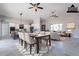 Open-concept living space featuring modern dining area, kitchen island, and comfortable seating area with large windows at 16405 N Cobblestone Ln, Fountain Hills, AZ 85268