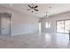 Large living room area featuring gray tile flooring, neutral walls, and a large sliding door at 16405 N Cobblestone Ln, Fountain Hills, AZ 85268