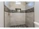 Modern shower featuring decorative tile, a built-in niche, and a rainfall showerhead at 16405 N Cobblestone Ln, Fountain Hills, AZ 85268