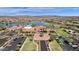 Stunning aerial view of the community center, lake, and mountains in a beautiful, planned residential area at 17002 S 178Th Ave, Goodyear, AZ 85338