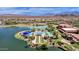 Aerial view of a pool, bocce ball court, and recreation area, nestled next to a picturesque lake at 17002 S 178Th Ave, Goodyear, AZ 85338