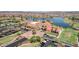 Aerial view of community center overlooking lake featuring spacious parking and manicured landscaping at 17002 S 178Th Ave, Goodyear, AZ 85338