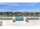Waterfront backyard with fire pit offers a serene escape with views of neighboring houses at 17002 S 178Th Ave, Goodyear, AZ 85338
