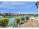 Scenic backyard view featuring a lake, lush landscaping, and outdoor living space on a sunny day at 17002 S 178Th Ave, Goodyear, AZ 85338