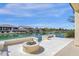 A home overlooking a beautiful waterfront, complete with a patio and fire pit at 17002 S 178Th Ave, Goodyear, AZ 85338