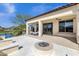 Expansive backyard featuring a fire pit, manicured lawn, and a tranquil waterfront view at 17002 S 178Th Ave, Goodyear, AZ 85338