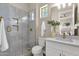 Modern bathroom with a marble shower, white vanity, gold fixtures, and stylish decor at 17002 S 178Th Ave, Goodyear, AZ 85338