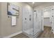 Modern bathroom showcasing a glass-enclosed shower with white marble tiling and wood-look flooring at 17002 S 178Th Ave, Goodyear, AZ 85338