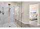 Contemporary bathroom with marble shower and views into the main bedroom and walk-in closet at 17002 S 178Th Ave, Goodyear, AZ 85338