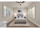 Inviting bedroom features plantation shutters, wood floors, a ceiling fan, and neutral decor at 17002 S 178Th Ave, Goodyear, AZ 85338