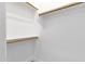 Clean, white walk-in closet featuring built-in shelving and ample storage space at 17002 S 178Th Ave, Goodyear, AZ 85338