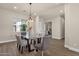 Bright dining room with a modern chandelier and large windows at 17002 S 178Th Ave, Goodyear, AZ 85338
