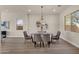 Modern dining room with wood floors, a glass table, and stylish chairs at 17002 S 178Th Ave, Goodyear, AZ 85338