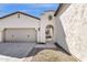 Inviting entrance with an arched doorway and a view of the courtyard at 17002 S 178Th Ave, Goodyear, AZ 85338