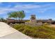Inviting community entrance with stone signage and lush landscaping at 17002 S 178Th Ave, Goodyear, AZ 85338