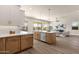 Open kitchen with island seating, stainless appliances and view to the living room at 17002 S 178Th Ave, Goodyear, AZ 85338