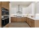 Kitchen with built-in oven, gas cooktop and stainless vent hood at 17002 S 178Th Ave, Goodyear, AZ 85338